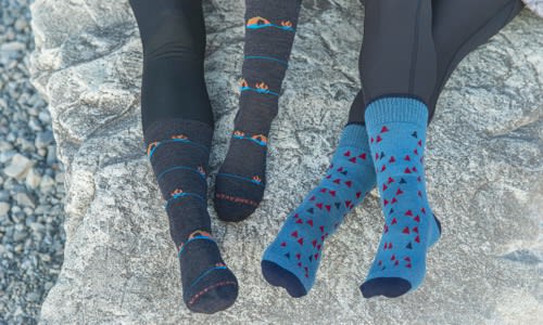 Two people sitting on a rock wearing icebreaker merino hiking socks