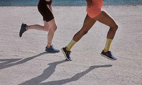 Two woman running waring icebreaker merino running socks