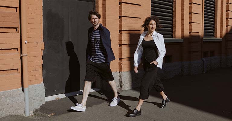 Man and woman walking down a street