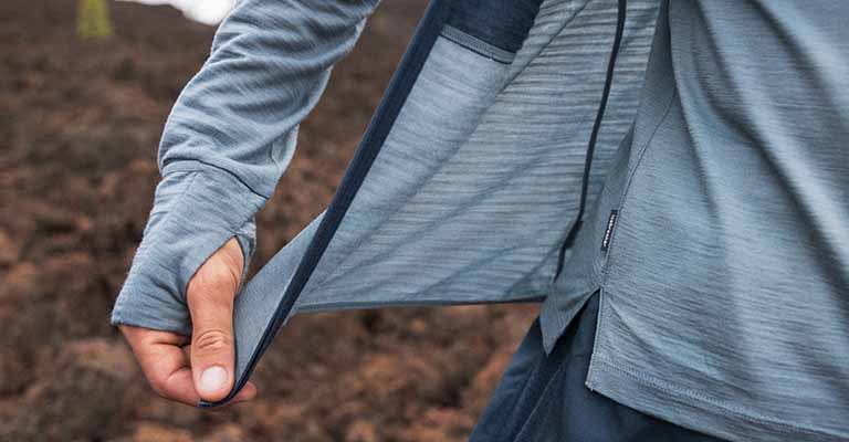 Person wearing a blue icebreaker merino descender hoodie