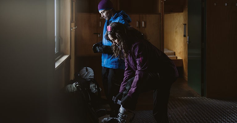 Man and woman getting ready to go skiing