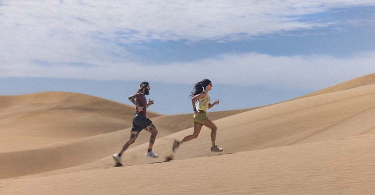Two people running wearing icebreaker featherlight merino t-shirts and merino running shorts