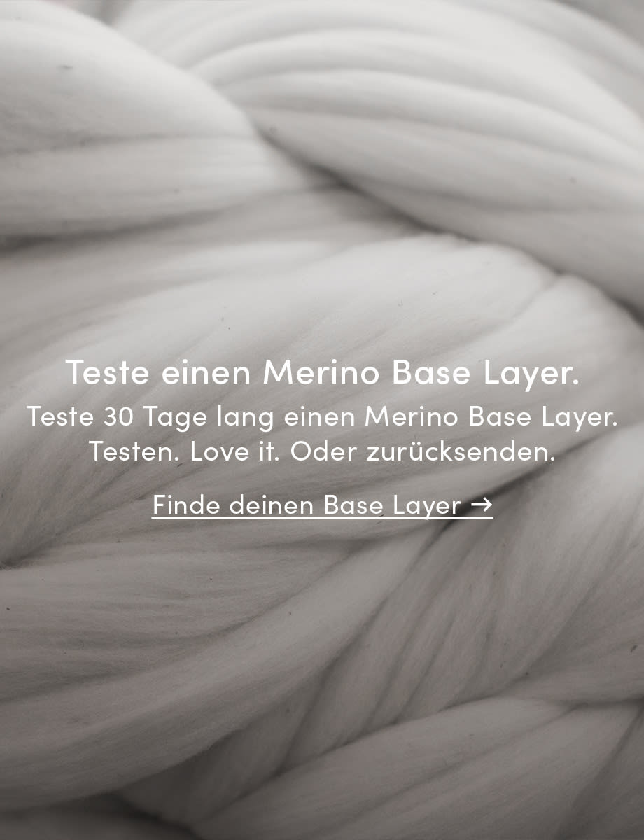 The image depicts a macro shot of white merino wool fiber. 