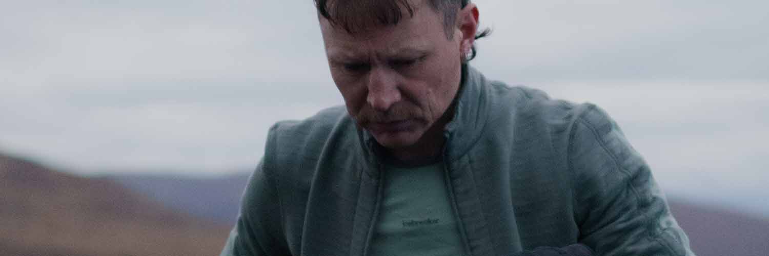 Man wearing icebreaker descender merino full zip sweatshirt