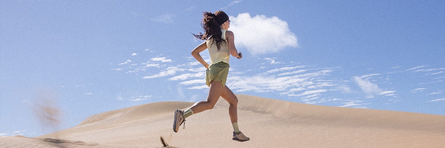 Woman running wearing icebreaker zoneknit merino tank and merino shorts