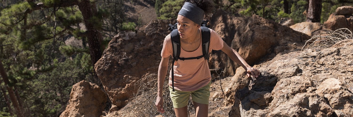 Woman hiking wearing icebreaker sphere merino hoodie