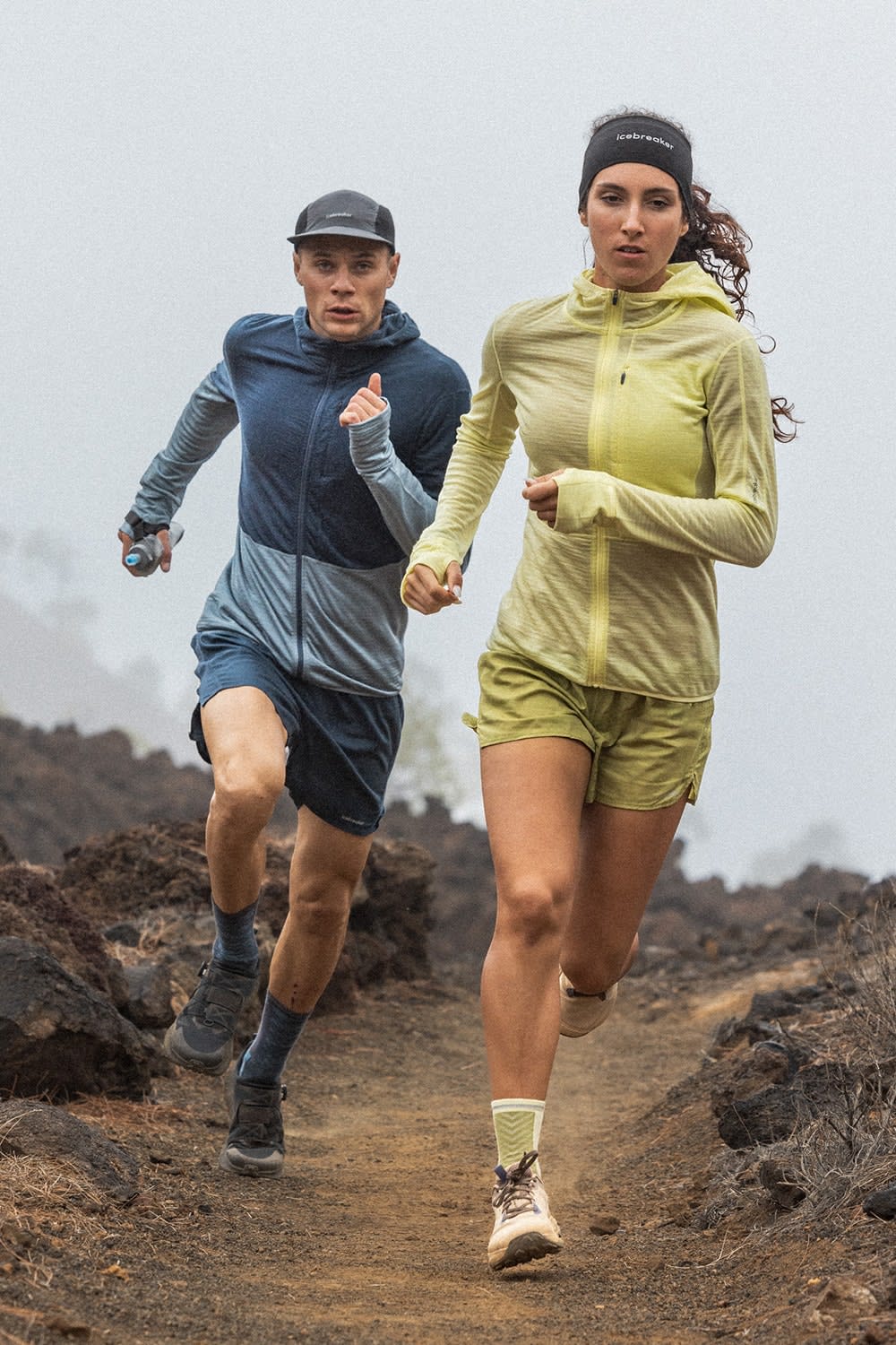 Man and woman running wearing icebreaker descender hoodies