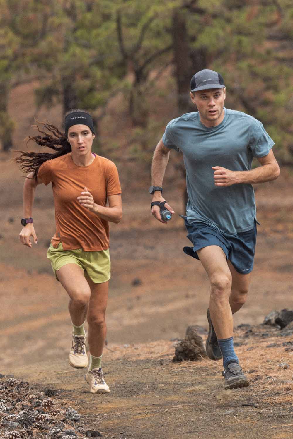 Man and woman running wearing icebreaker Ace merino t-shirt and merino running socks