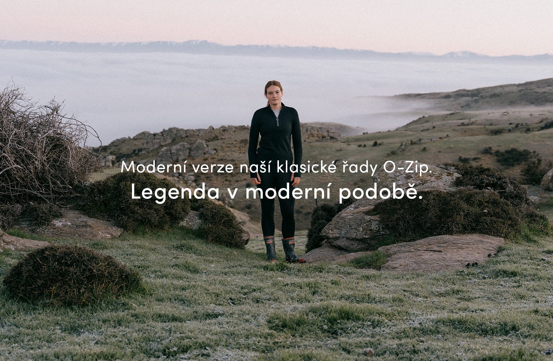 A girl standing outside in nature on a mountain, there are clouds below her. She is wearing the icebreaker o zip mid layer. There is text on the image that reads "a modern update to our classic o-zip. An updated icon."

Click on image to discover more.