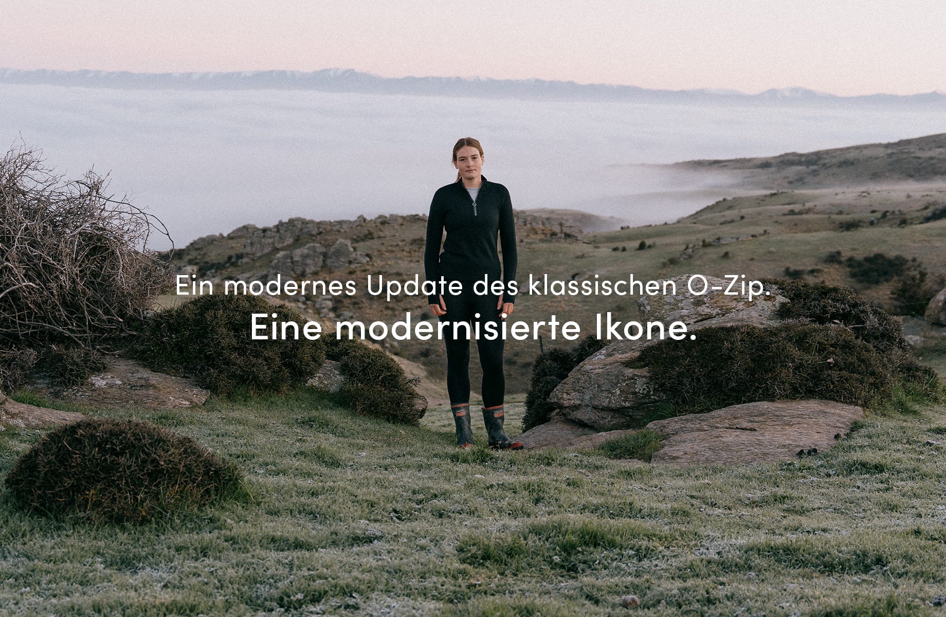 A girl standing outside in nature on a mountain, there are clouds below her. She is wearing the icebreaker o zip mid layer. There is text on the image that reads "a modern update to our classic o-zip. An updated icon."

Click on image to discover more.