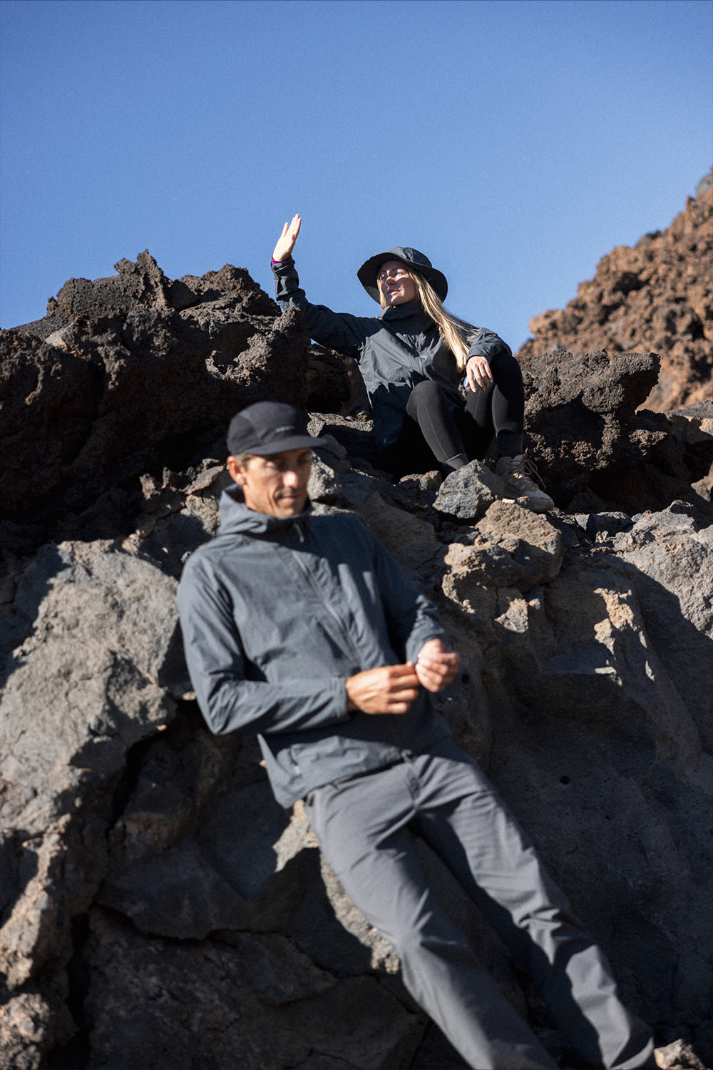 Two people outside wearing the icebreaker windbreaker jacket.