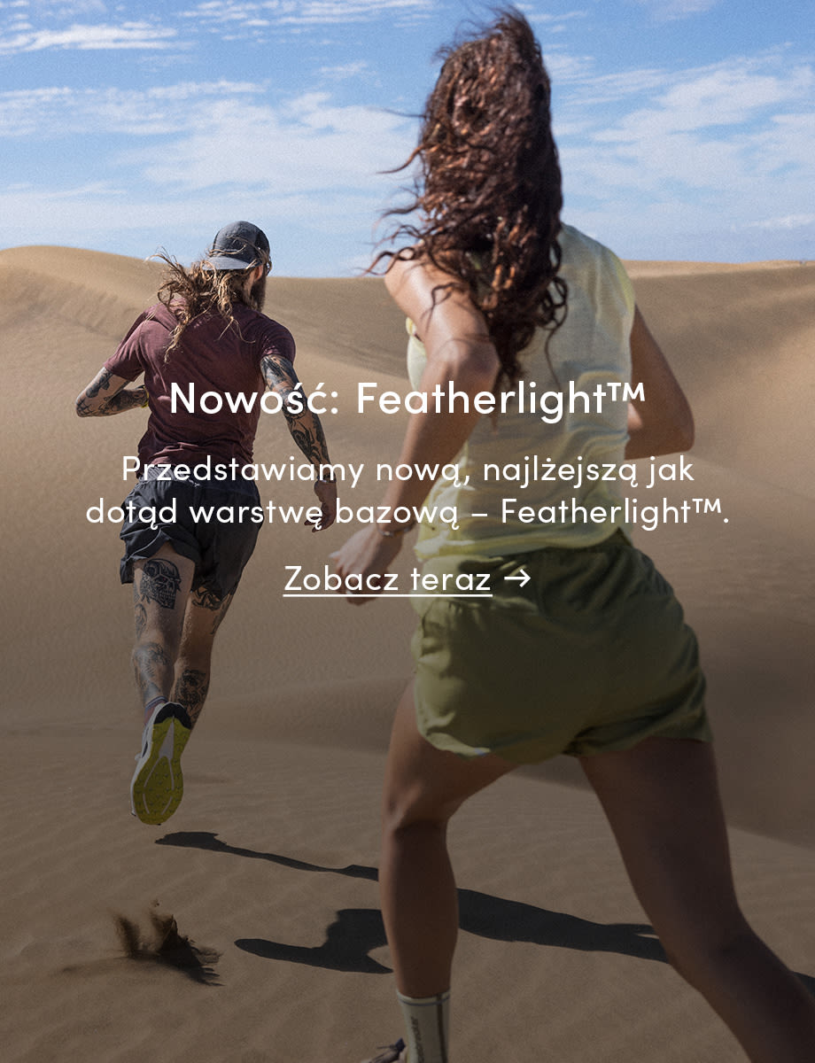 Two people running in icebreaker featherlight in the sand. The text on the image reads: New: Featherlight. Introducing the new Featherlight base layer, our lightest yet. Click on the image to shop now.