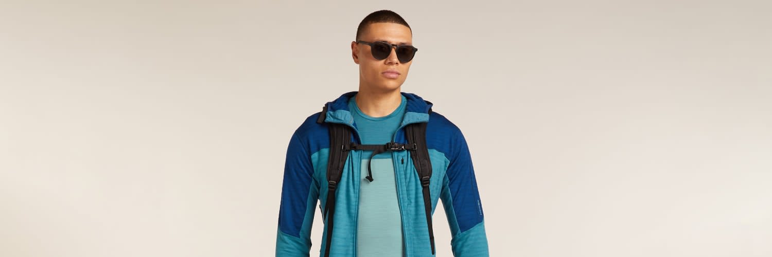 Man hiking wearing icebreaker sphere merino t-shirt and merino descender hoodie