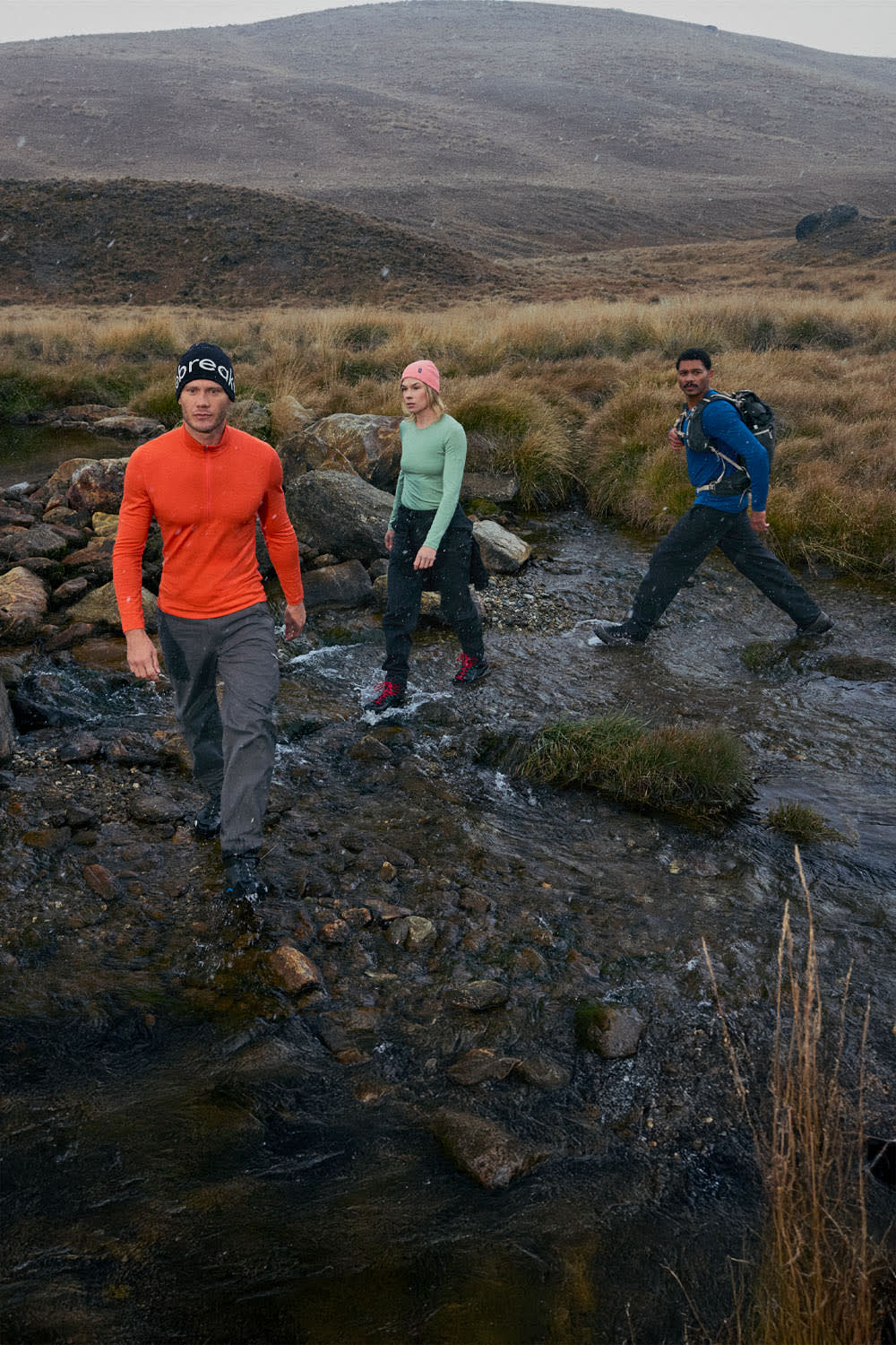 Three people hiking wearing icebreaker merino base layer thermal tops and merino hiking pants