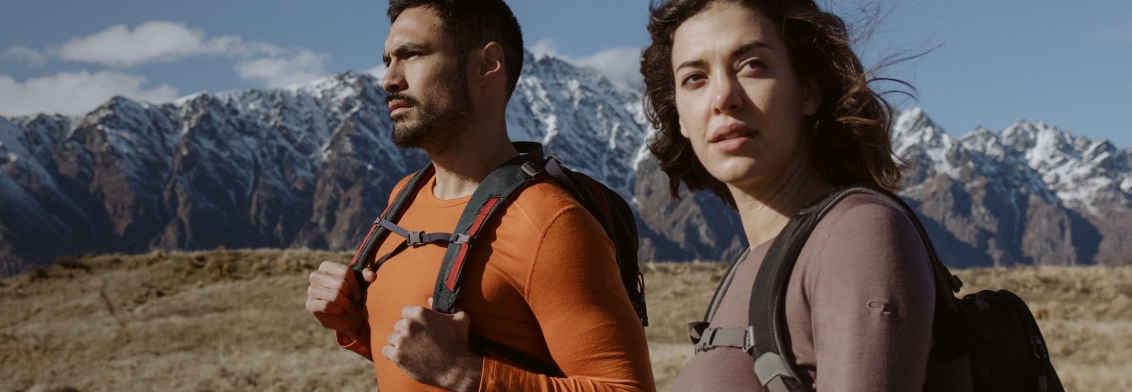 Man and woman hiking wearing icebreaker merino base layers