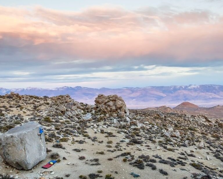 Man bouldering Buttermilk Rocks in Bishop California