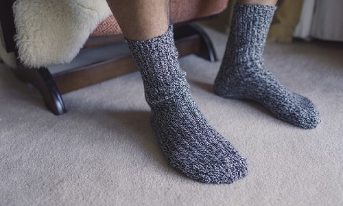 Person sitting wearing merino wool socks
