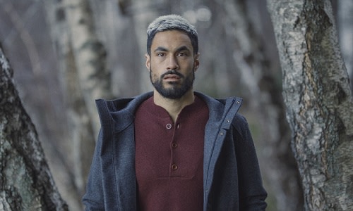 Man standing in front of a tree wearing icebreaker merino Ainsworth Jacket and Abbeyfield sweater