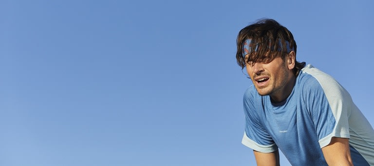 Man exercising wearing a blue icebreaker merino zoneknit t-shirt