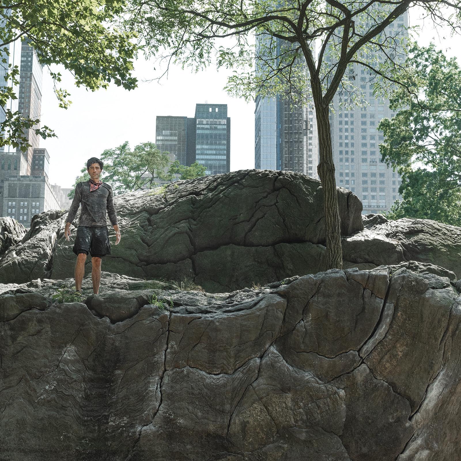 Adrian Grenier standing on a rock