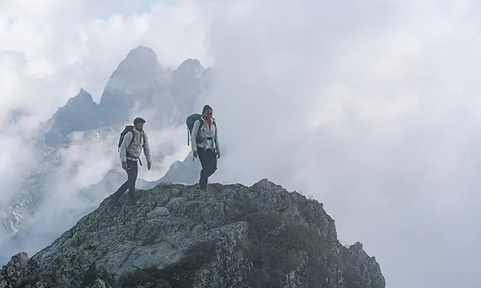 Man & Women hiking up a mountain wearing RealFleece™ Merino High Pile Long Sleeve Zip Jacket.