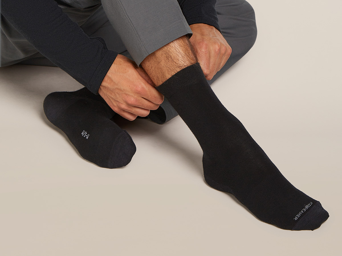 Person putting on icebreaker merino dress socks